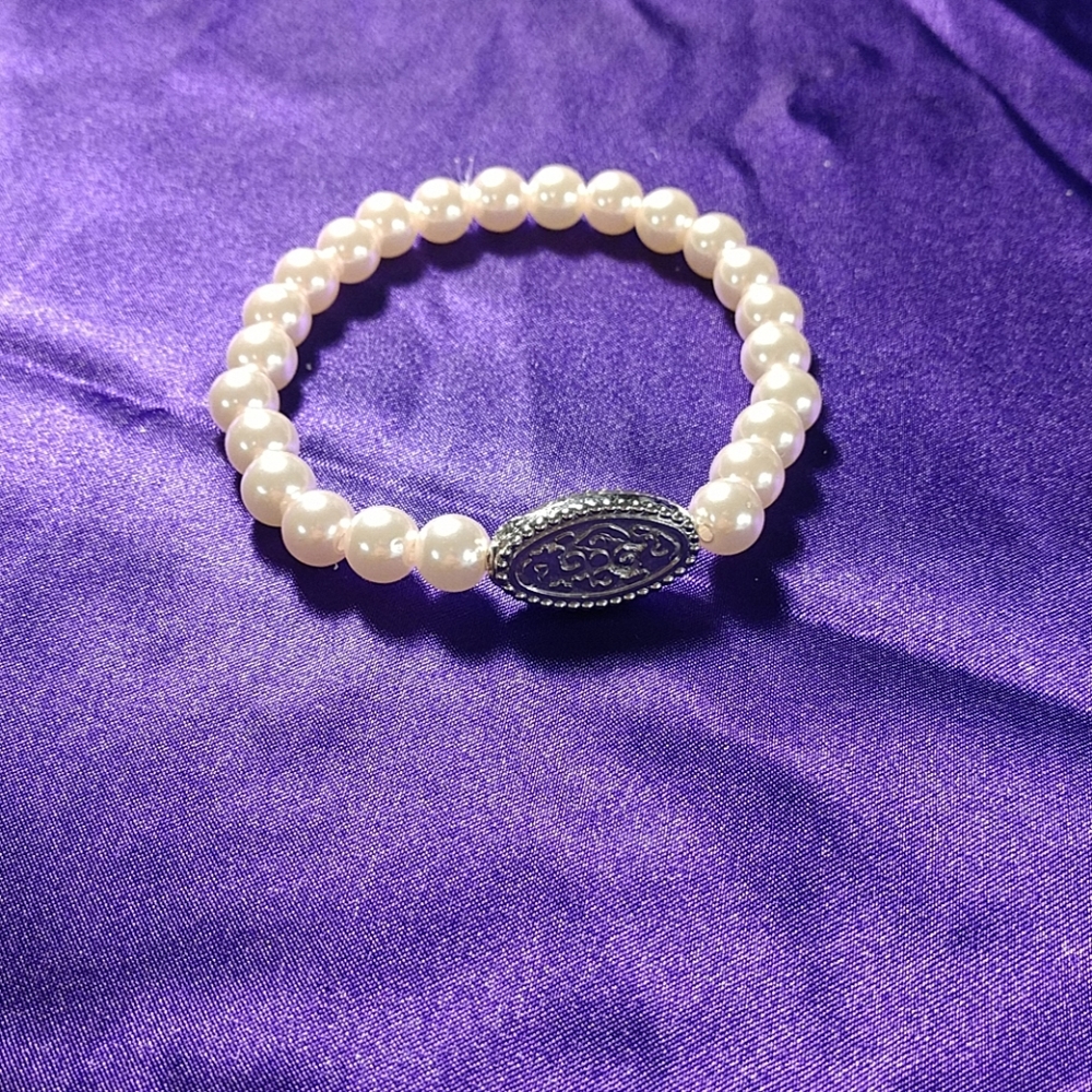 pink bracelet with pretty metal piece